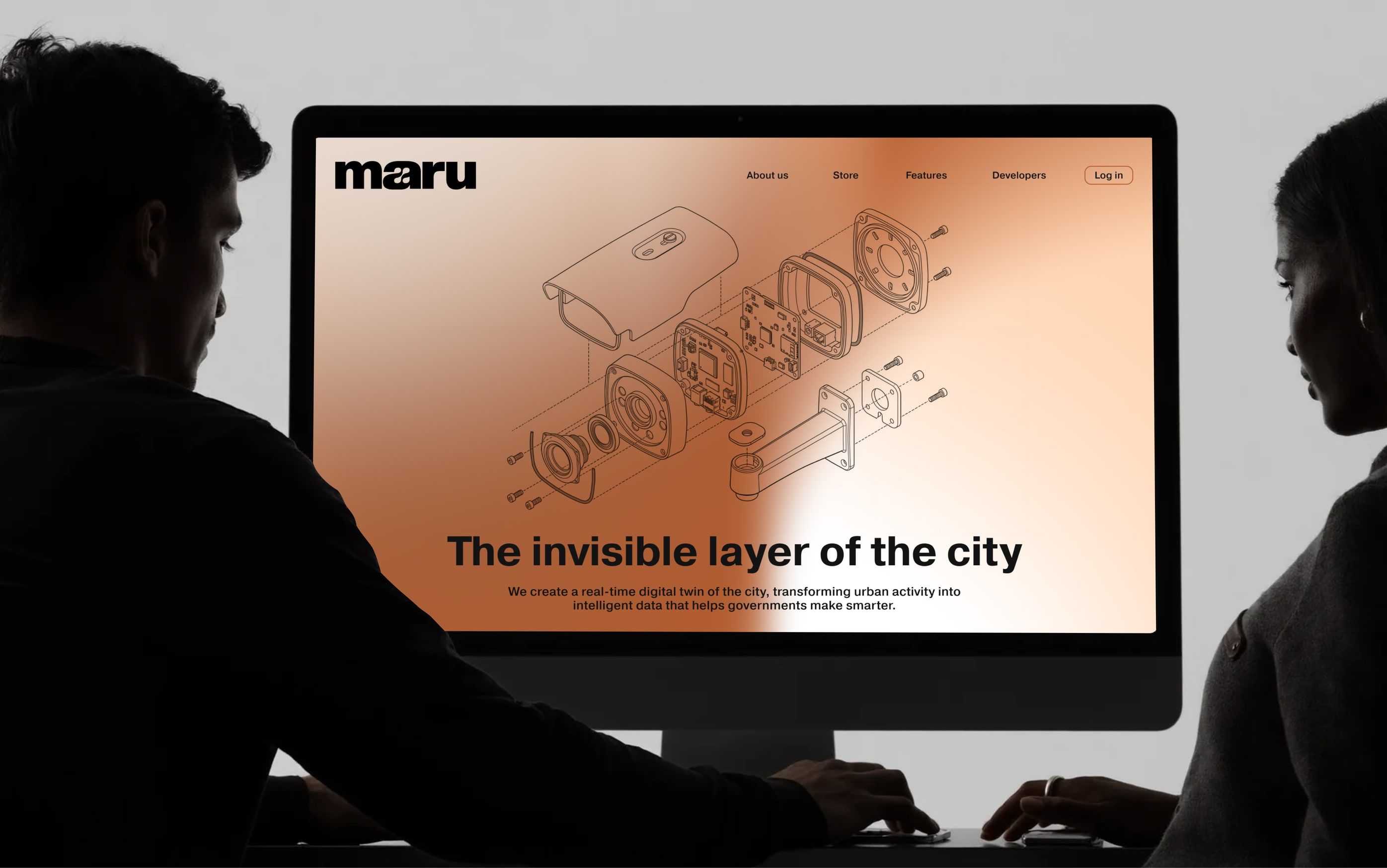 two people viewing the maru website with an exploded technical drawing of an urban camera