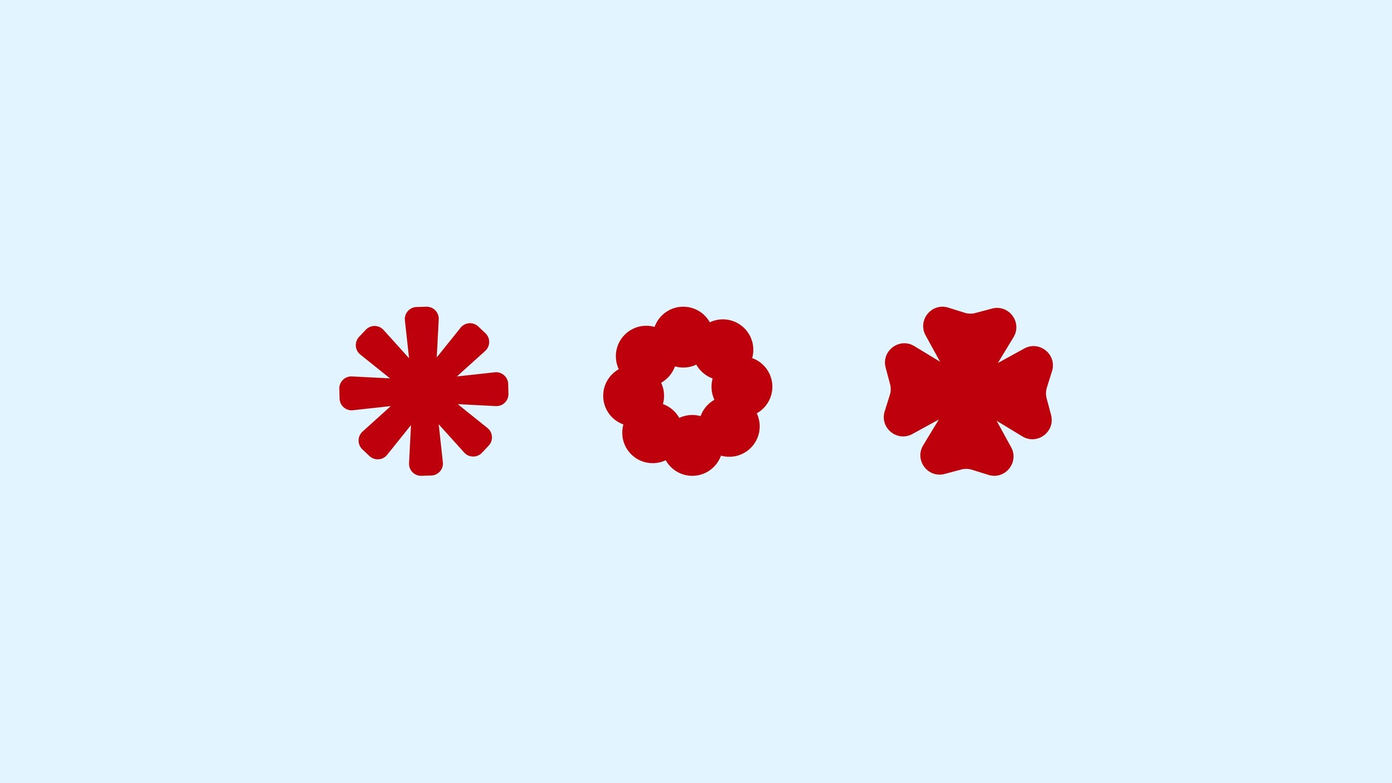 three red symbols derived from flower, cloud and star-like rounded forms on sky blue