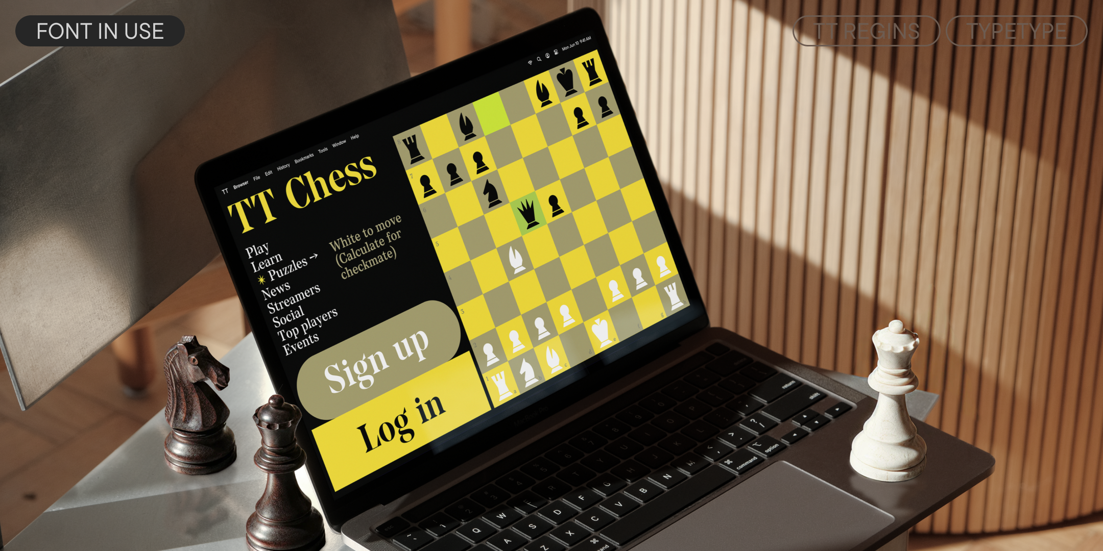 a yellow and black chess website using tt regins on a laptop