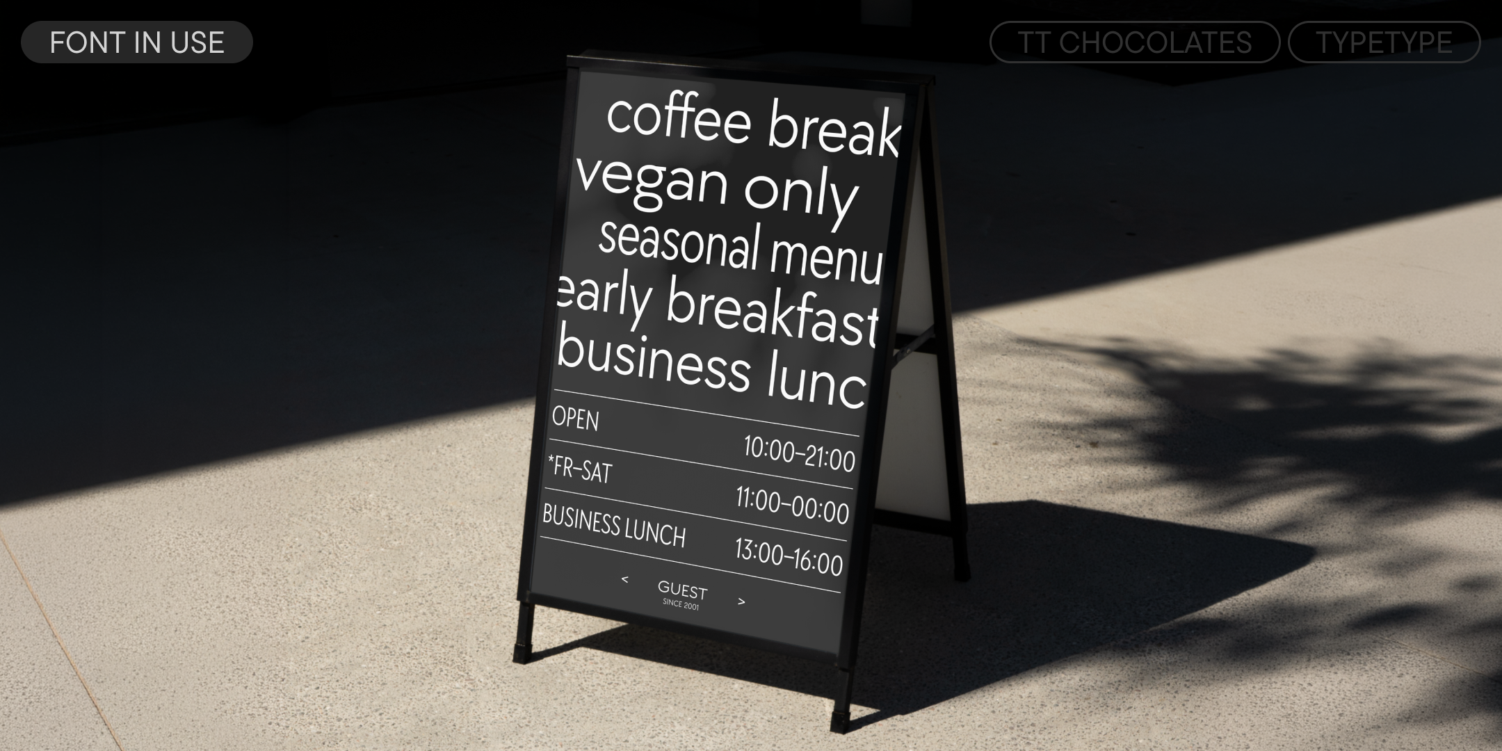 tt chocolates on a black pavement sign advertising a café menu