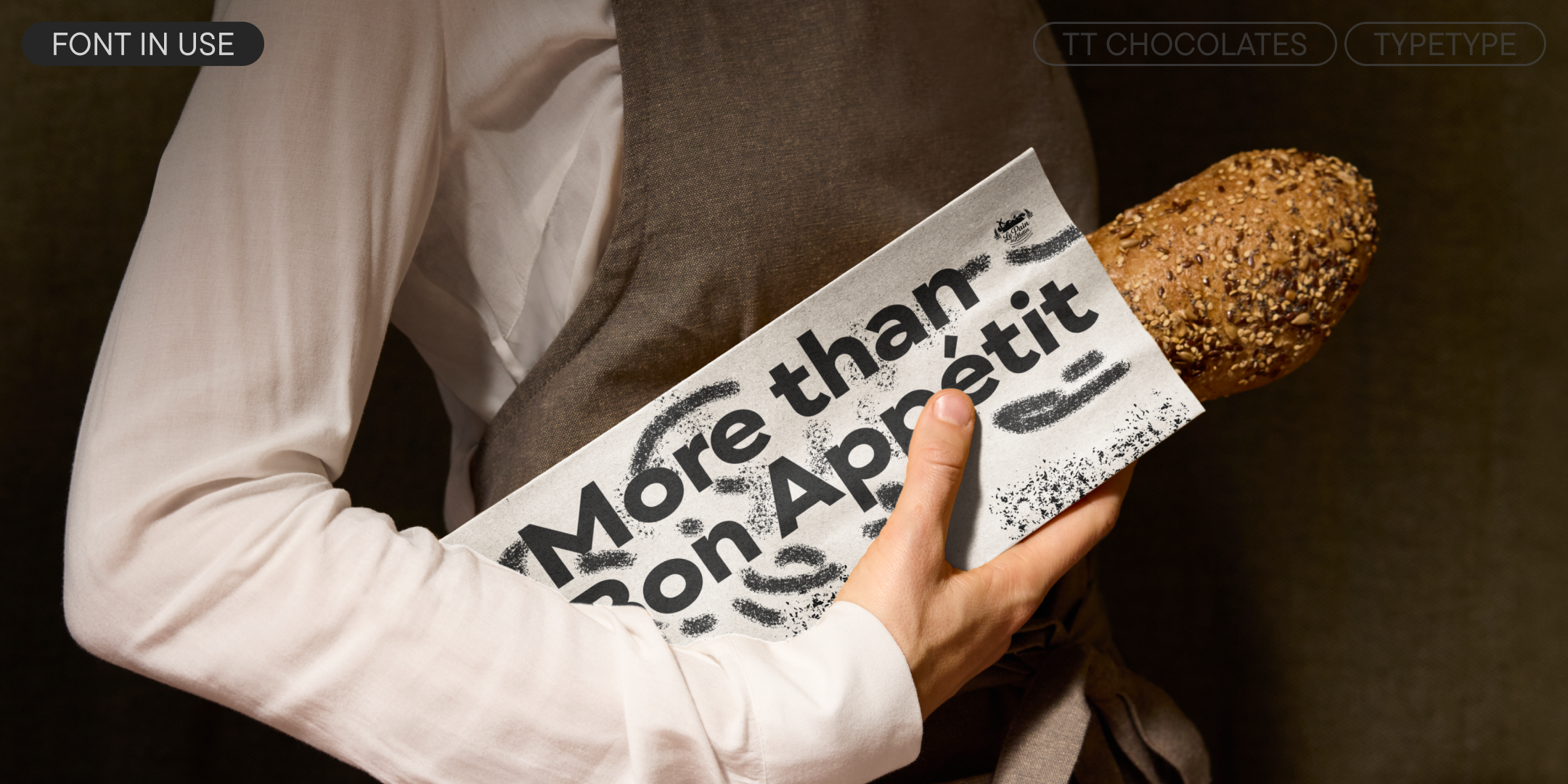 tt chocolates on a paper bakery bag holding a seeded baguette