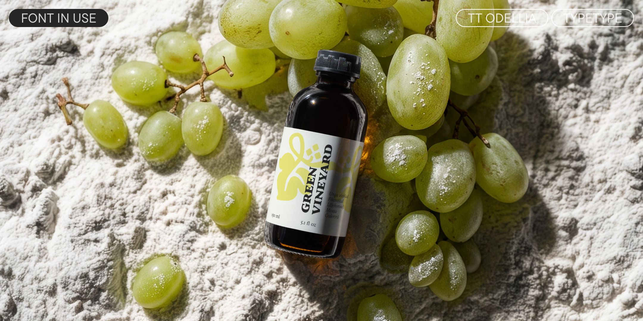 tt odellia on a grape-seed oil bottle among green grapes