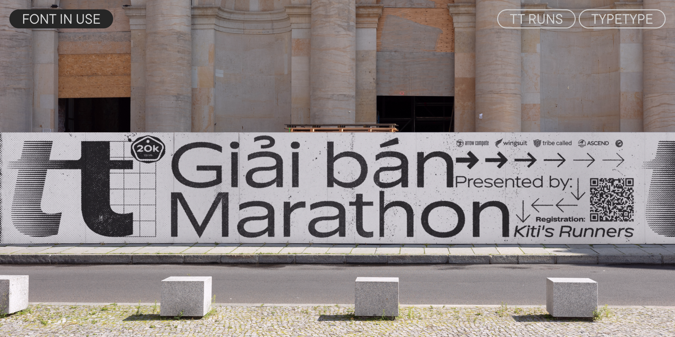 tt runs on a marathon banner outside a stone building
